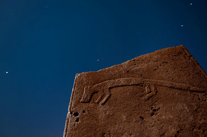 petroglyphed stone and starry sky