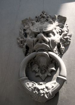 door knocker as satyr face with ring in teetch